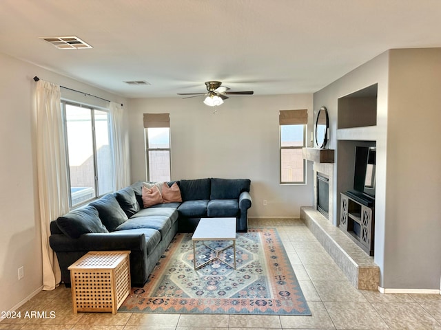 living room with light tile patterned floors and ceiling fan