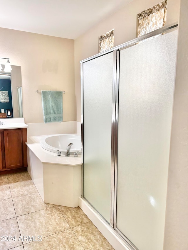 bathroom with vanity, tile patterned floors, and plus walk in shower