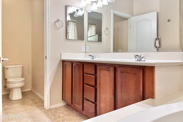 bathroom with vanity, toilet, and tile patterned flooring