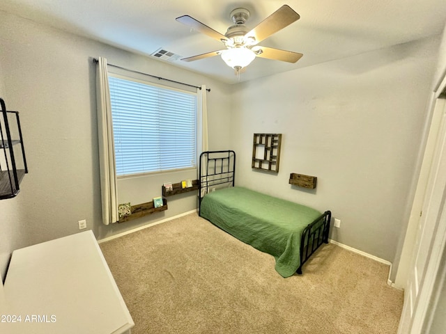 bedroom featuring light colored carpet and ceiling fan