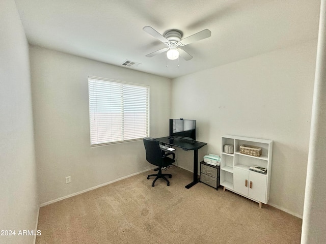 carpeted office space featuring ceiling fan