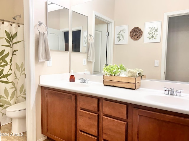 bathroom featuring vanity, a shower with shower curtain, and toilet