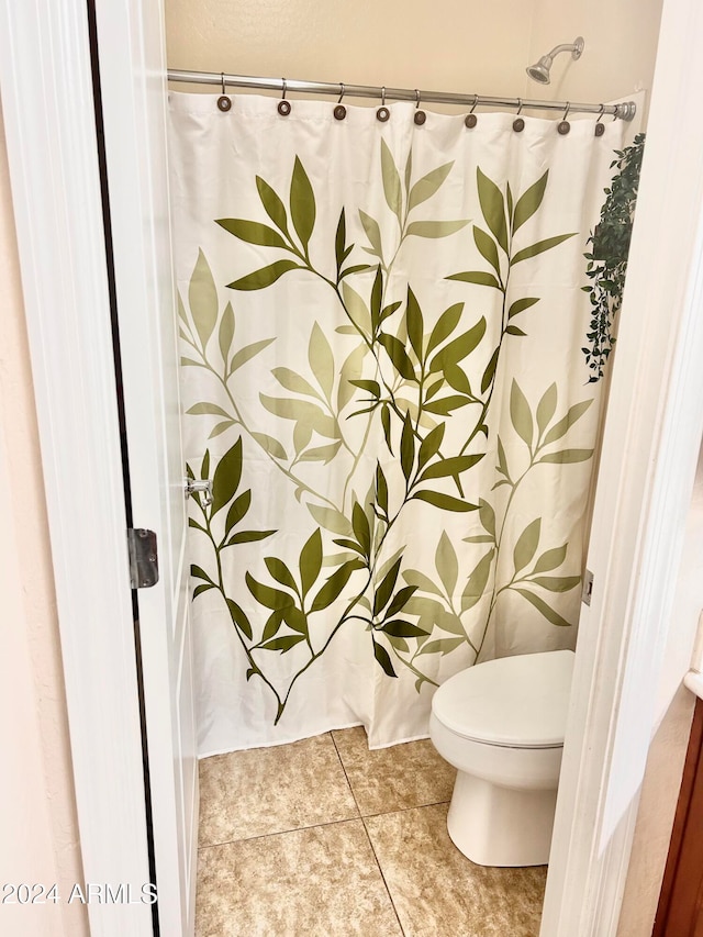 bathroom with tile patterned floors and toilet