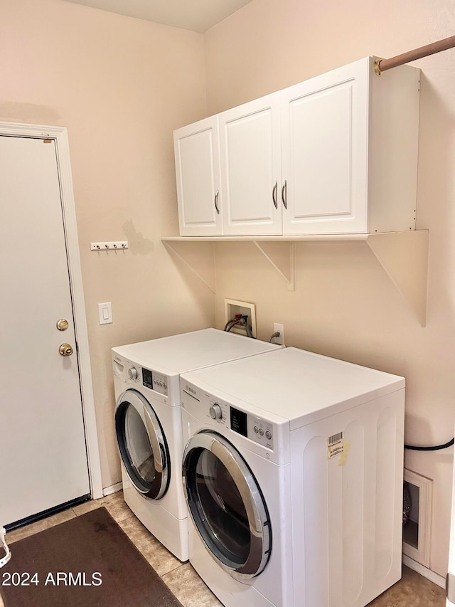 washroom featuring cabinets and separate washer and dryer