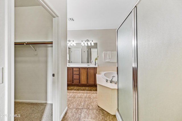 bathroom with vanity, tile patterned floors, and separate shower and tub