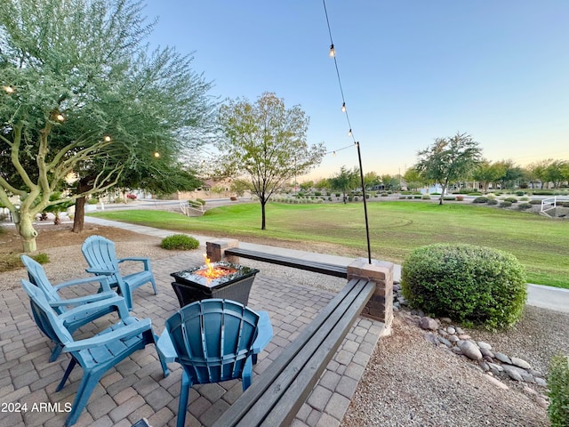 view of property's community with a yard, a patio area, and a fire pit