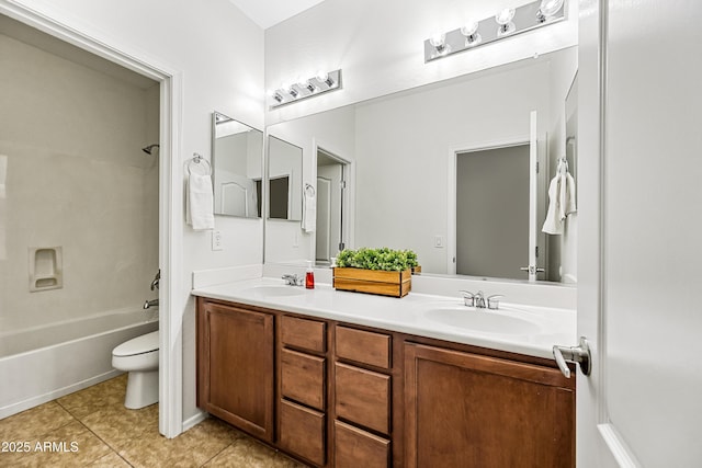 full bathroom featuring vanity, tile patterned floors, toilet, and washtub / shower combination