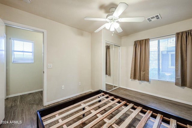 unfurnished room featuring dark hardwood / wood-style floors, ceiling fan, and a healthy amount of sunlight