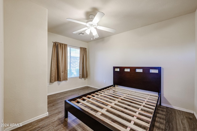 bedroom featuring ceiling fan and dark hardwood / wood-style flooring