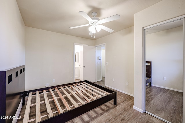 bedroom with ceiling fan, a closet, and hardwood / wood-style flooring