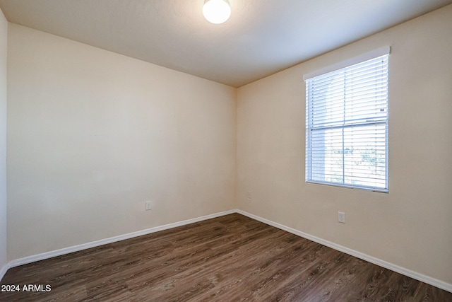 spare room with dark wood-type flooring