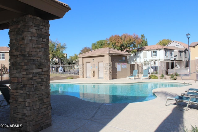 view of swimming pool with a patio area and an outdoor structure