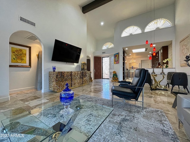 10068 E Turquoise Ave, Scottsdale, AZ 85258 - living room with baseboards, visible vents, and arched walkways