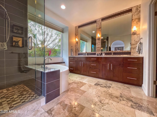 10068 E Turquoise Ave, Scottsdale, AZ 85258 - bathroom with a stall shower, a freestanding bath, vanity, and stone finish floor