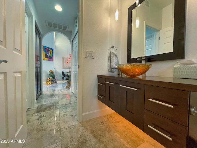 10068 E Turquoise Ave, Scottsdale, AZ 85258 - bathroom with baseboards, visible vents, and vanity
