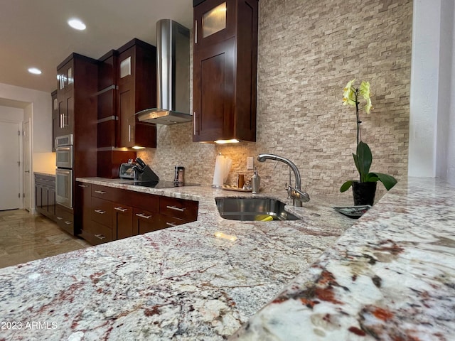 10068 E Turquoise Ave, Scottsdale, AZ 85258 - kitchen with a sink, wall chimney exhaust hood, light stone countertops, tasteful backsplash, and black electric cooktop