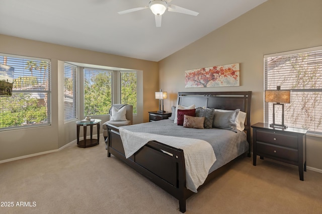 bedroom featuring a ceiling fan, light carpet, baseboards, and lofted ceiling