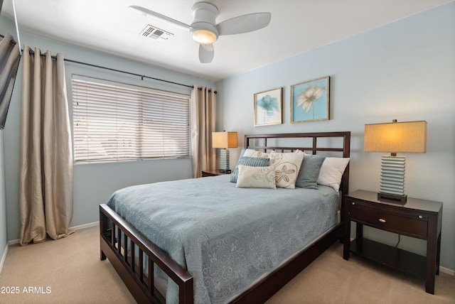 carpeted bedroom featuring baseboards, ceiling fan, and visible vents