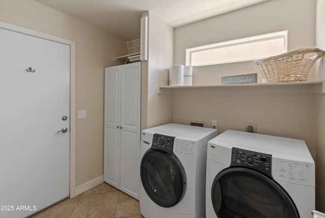 laundry room featuring light tile patterned flooring, cabinet space, independent washer and dryer, and baseboards