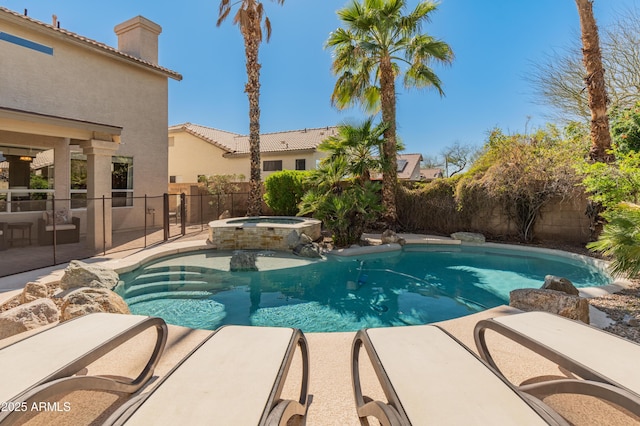 view of pool featuring a fenced in pool, a fenced backyard, and an in ground hot tub