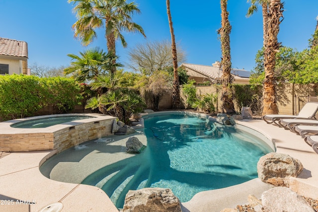 view of pool featuring a fenced backyard, a fenced in pool, and an in ground hot tub