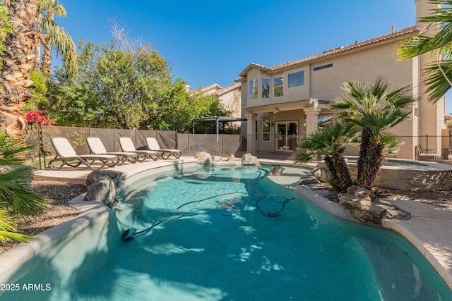 view of pool featuring a patio, an in ground hot tub, fence, and a fenced in pool