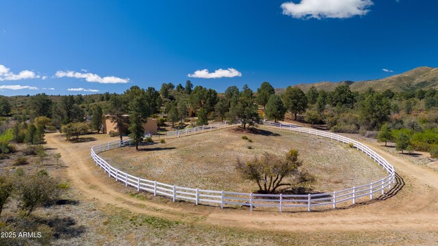 view of community featuring fence and a rural view