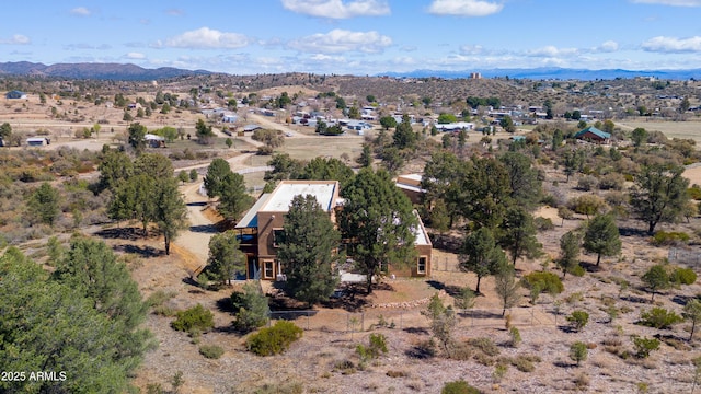 drone / aerial view featuring a desert view and a mountain view