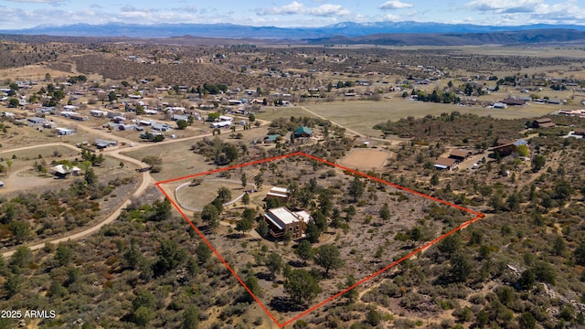 birds eye view of property with a mountain view, a rural view, and view of desert