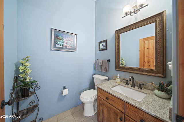 half bathroom featuring vanity, tile patterned flooring, and toilet