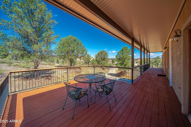 wooden terrace with outdoor dining space