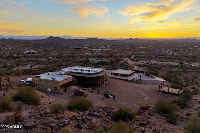 aerial view at dusk featuring a mountain view