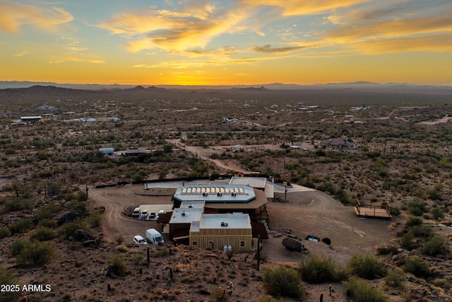 aerial view at dusk featuring a mountain view