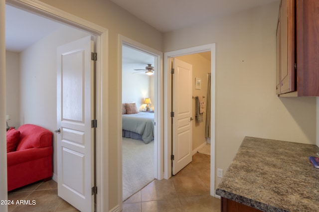 interior space featuring ceiling fan and light tile patterned floors