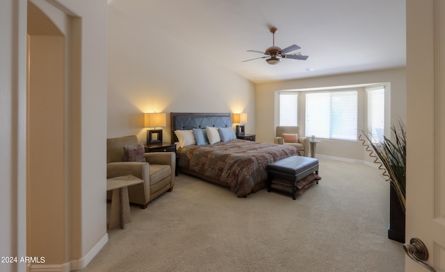 carpeted bedroom featuring ceiling fan and vaulted ceiling