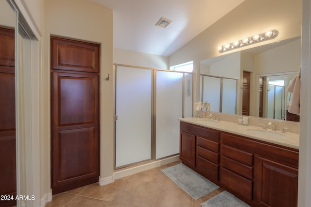 bathroom with lofted ceiling, vanity, an enclosed shower, and tile patterned flooring