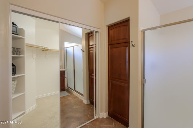 interior space featuring lofted ceiling and tile patterned floors