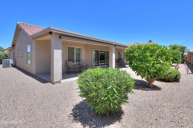 rear view of property featuring cooling unit and a patio