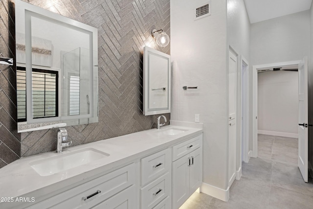 bathroom featuring vanity and decorative backsplash