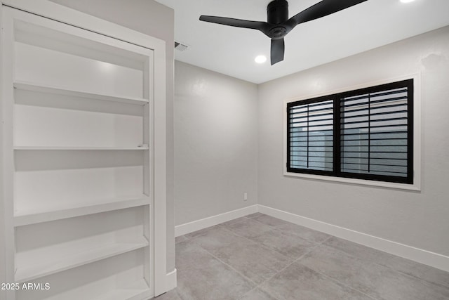 empty room featuring ceiling fan and built in features