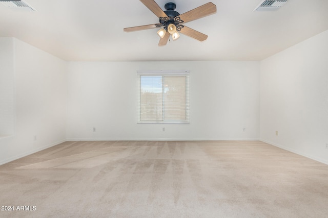 unfurnished room featuring ceiling fan and light colored carpet