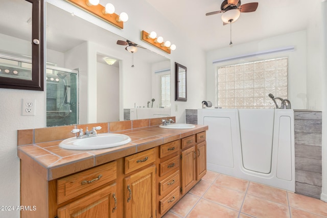 bathroom with tile patterned flooring, vanity, ceiling fan, and separate shower and tub