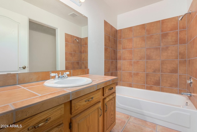 bathroom with vanity, tile patterned floors, and tiled shower / bath combo