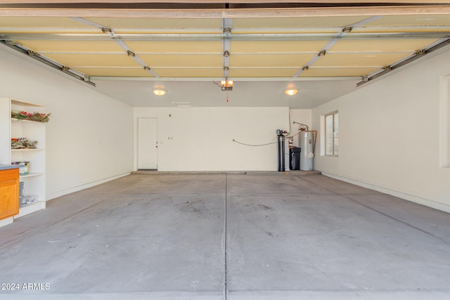 garage with water heater and a garage door opener