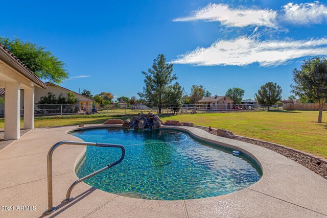 view of pool featuring a lawn and a patio