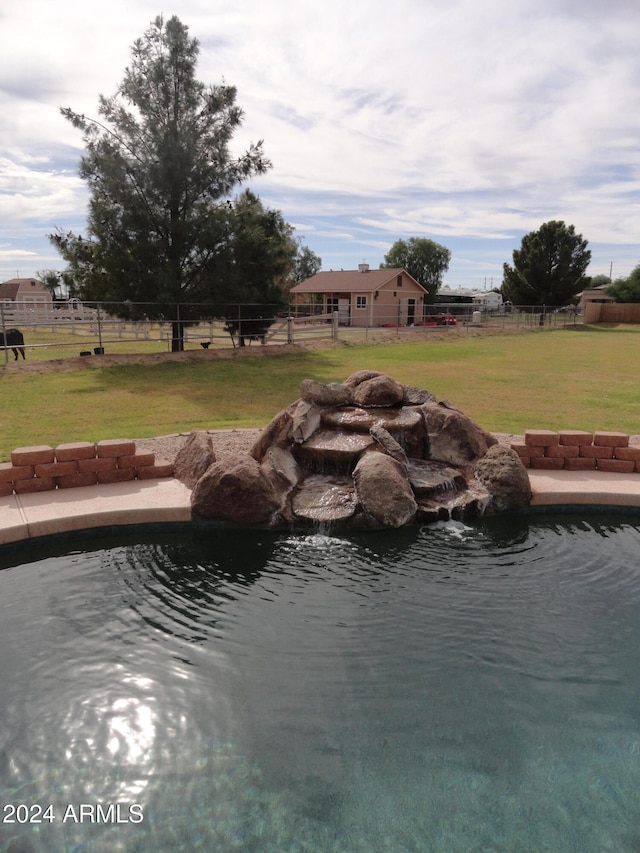 view of swimming pool featuring a lawn