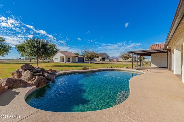 view of pool featuring a lawn and a patio area