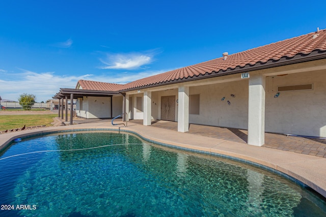 view of swimming pool with a patio area