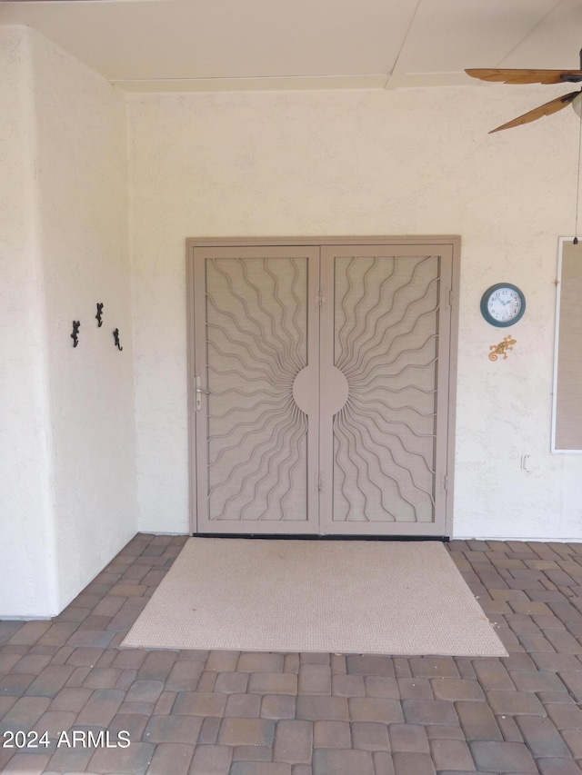 doorway to property featuring ceiling fan