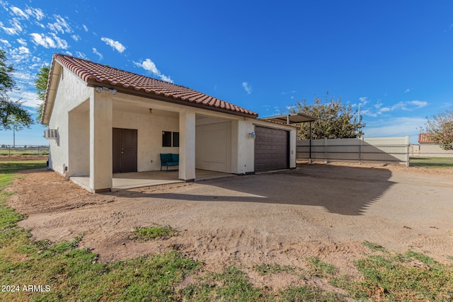 rear view of house with a garage